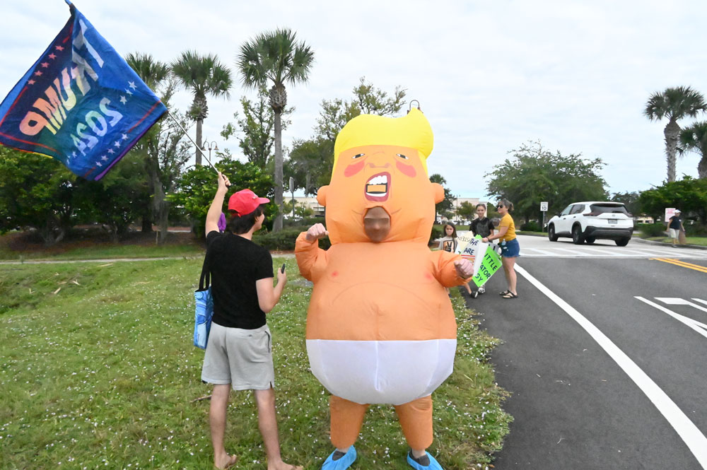 Trump 2024 on one side, a trans flag on the other. And an encounter with someone who was not a fan. (© FlaglerLive)