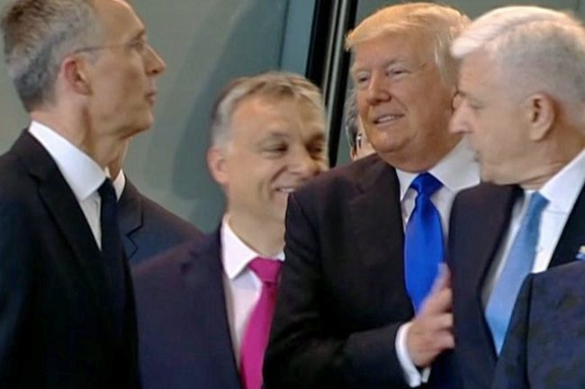 The ugly American in Europe: President Trump shoves his way past Dusko Markovic, the leader of Montenegro, at the NATO summit this week. 