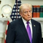 Donald Trump on Friday at the White House, standing next to a sign that claimed savings of "1.3 trillion for taxpayers. (White House)