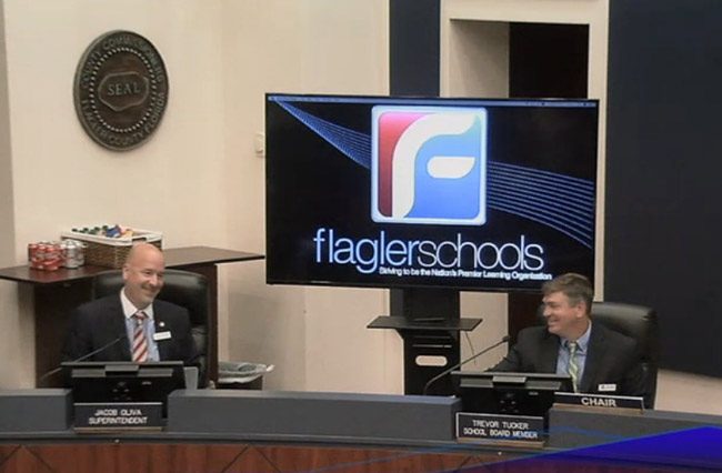 Flagler County School Board Chairman Trevor Tucker, right, with Superintendent Jacob Oliva, who heard several tributes this evening as he preparees to give way to Superintendent James Tager, whose contract was approved this evening. (© FlaglerLive)