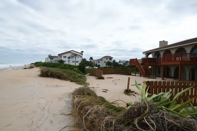 The house at the end of Moody Drive in north Flagler County, the demarcation between its front porch and the beach no longer clear. (© FlaglerLive)
