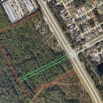The U-Haul property where the future storage facility will be built is marked in red. The right-of-way for the future westward extension of Whiteview Parkway is marked in green. (© FlaglerLive via Google Earth)