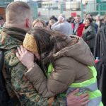 A woman hugs a Polish volunteer before he crosses the border to go and fight against Russian forces.