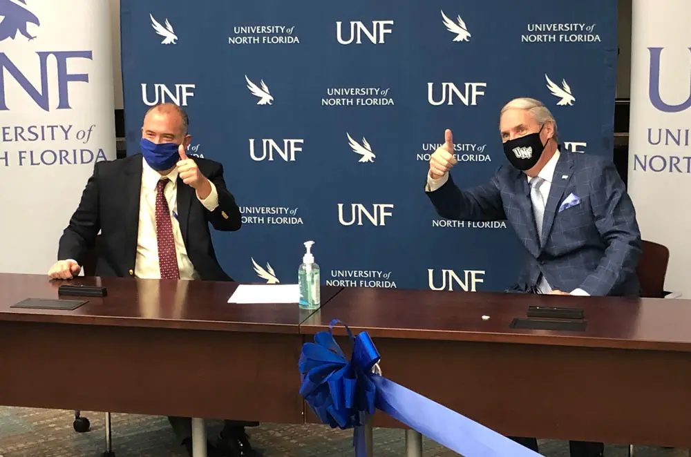 DSC President Tom LoBasso, left, and UNF President David Szymanski an official Memorandum of Understanding between the two institutions at the Oct. 6 press conference. The schools hope their collaboration that will further elevate healthcare education and support the specific needs of the region. (© FlaglerLive)