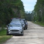 A row of unmarked cars on Elder Street this afternoon, by the Bryan Jacskon property (to the right), as FBI and Flagler County Sheriff's investigators worked the scene. (© FlaglerLive)