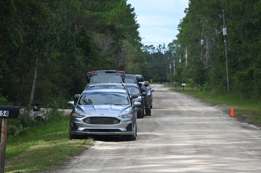 A row of unmarked cars on Elder Street this afternoon, by the Bryan Jacskon property (to the right), as FBI and Flagler County Sheriff's investigators worked the scene. (© FlaglerLive)
