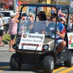 A vacation rental company entered the Flagler Beach Independence Day parade in 2018. (© FlaglerLive)