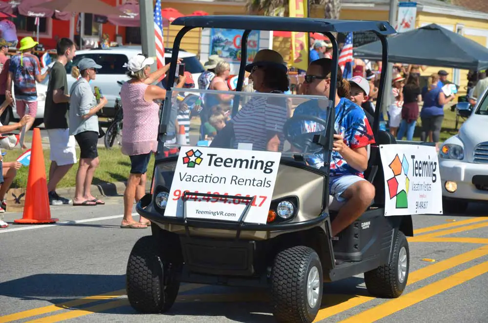 A vacation rental company entered the Flagler Beach Independence Day parade in 2018. (© FlaglerLive)