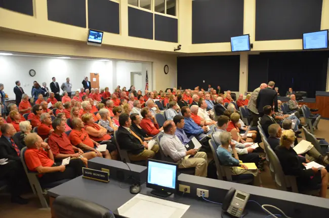 A red sea of opponents of a 2011 law preventing most county regulation of vacation rentals demanded of Rep. Travis Hutson and Sen. John Thrasher that the pre-emption be repealed. Thrasher and Hutson were in Flagler County for the annual legislative delegation meeting, Wednesday afternoon in Bunnell, which took place early this year. (© FlaglerLive)