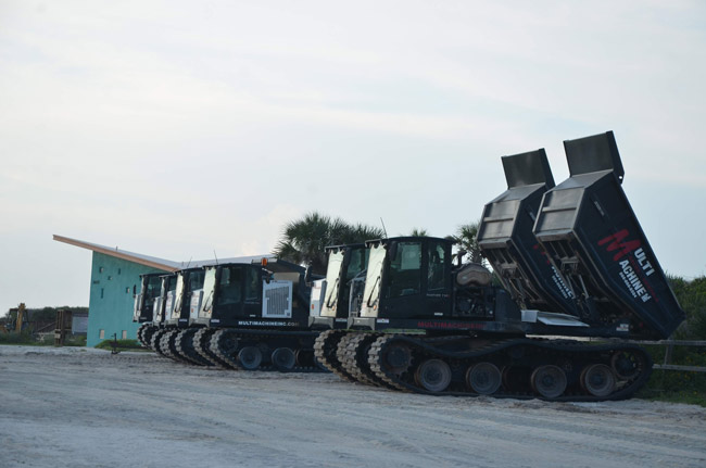 The line-up of dune-rebuilding and dumping machines at Varn Park along A1A, as the rebuilding continues. (© FlaglerLive)