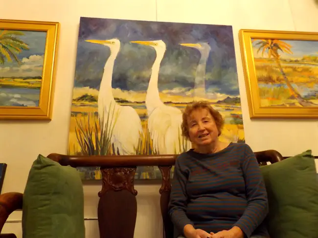 Flagler Artist of the Year Trish Vevera with her painting, 'And Then There Were Two.' (c FlaglerLive)
