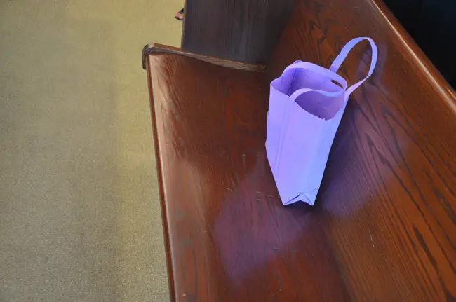The purple bag that often accompanies the victim's advocate in Flagler County court. The bag contains tissue paper and comfort items for victims who sit through their assailant's trials or hearings. (© FlaglerLive)