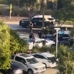 A chase involving the Florida Highway Patrol and two people in a white car ended in a shooting in the parking lot area of the Hammock Beach Resort. (© FlaglerLive)