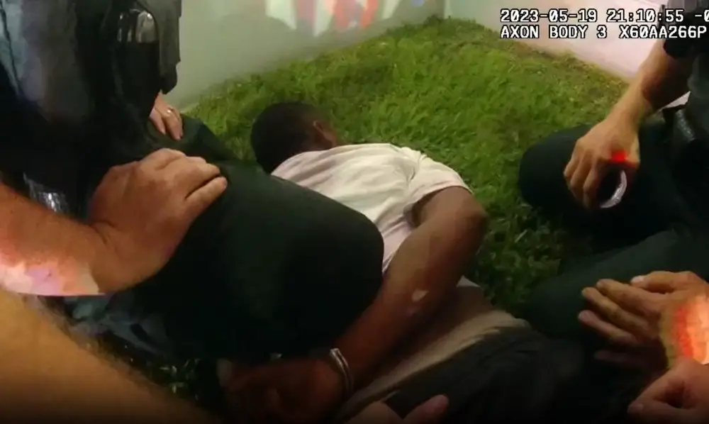 "After suffering various choke holds, being kneed to his ribs and tased multiple times, Virgilio's hands were cuffed," a motion describing the arrest of migrant worker Virgilio Mendez reads. (Still from body cam footage)