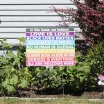 A sign in a yard listing many virtues – an example of virtue signaling.