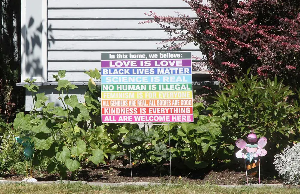 A sign in a yard listing many virtues – an example of virtue signaling. 