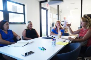 Volunteers at work: Colleen Conklin, right, meeting with her team this morning to take stock of the relief effort and what's ahead. From left, Nikki Osmun, Tracy Callahan and Melissa Vaculik. Click on the image for larger view. (© FlaglerLive)