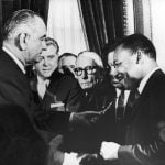 President Lyndon Johnson hands a pen to civil rights leader Rev. Martin Luther King Jr. during the signing of the Voting Rights Act in Washington, D.C., on Aug. 6, 1965.