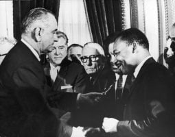 President Lyndon Johnson hands a pen to civil rights leader Rev. Martin Luther King Jr. during the signing of the Voting Rights Act in Washington, D.C., on Aug. 6, 1965.