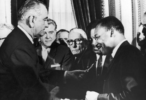 President Lyndon Johnson hands a pen to civil rights leader Rev. Martin Luther King Jr. during the signing of the Voting Rights Act in Washington, D.C., on Aug. 6, 1965.
