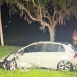 The Volkswagen GTI after it was pulled out of the retention pond at the 289 exit off I-95 this morning. (© FlaglerLive)