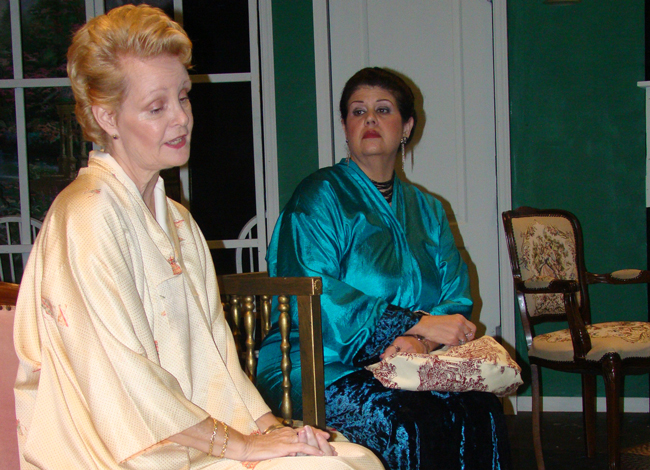 Contempt and contre-temps: the icy May Davenport (Anji Brazell) looks down on her old rival Lotta Bainbridge (Kathy Thompson) before their reconciliation in 'Waiting in the Wings.' (Flagler Playhouse)