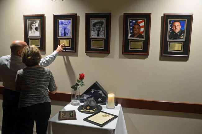 The five fallen officers at the Wall of Honor at what used to be the Sheriff's Operations Center. (© FlaglerLive)