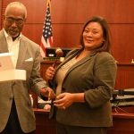 Judge Alicia Washington receiving a ceremonial gavel from Howard Holley. (© FlaglerLive)