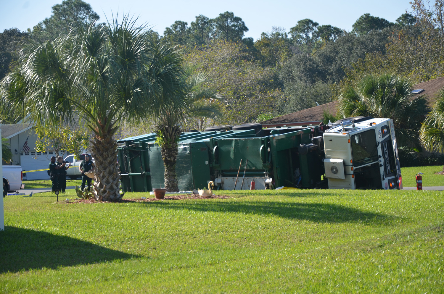 The Waste Pro garbage truck overturned in front of 1 Bay Spring Place in Palm Coast's Woodlands this morning, killing a man. (c FlaglerLive)