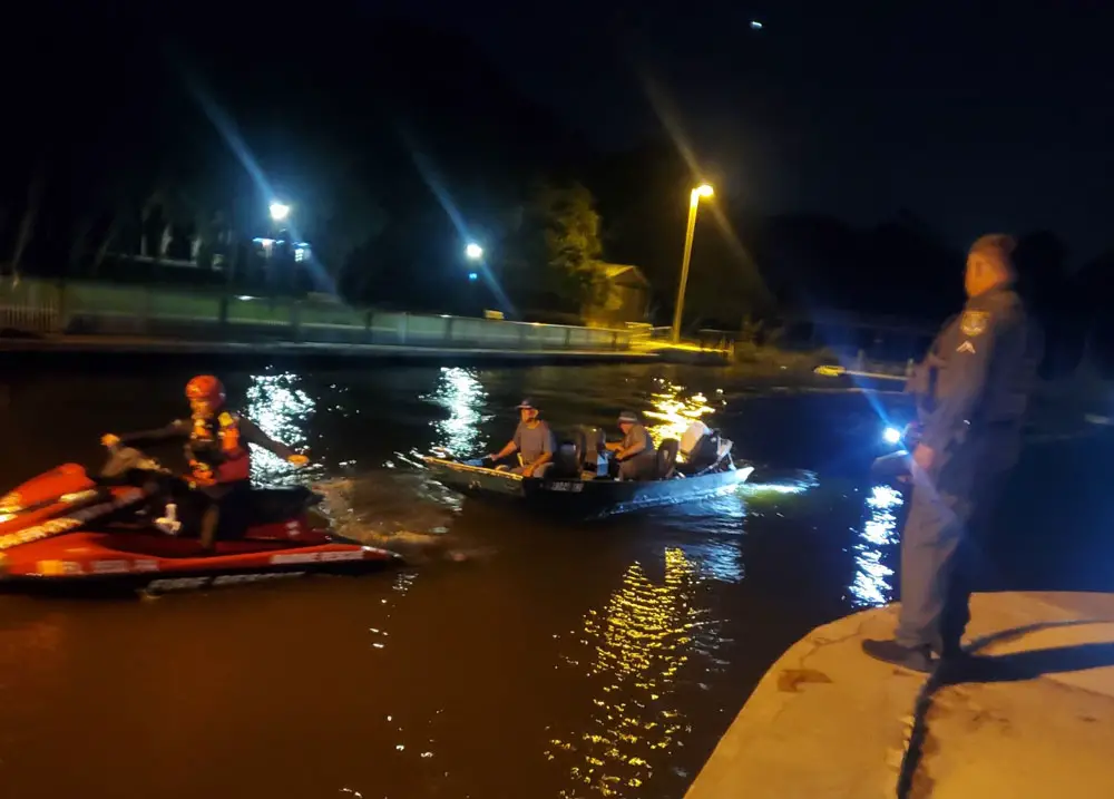 A Flagler County Fire Rescue paramedic tows the two men, stranded in a john boat for over six hours, back to shore at Bing's Landing Friday night. (FCSO)