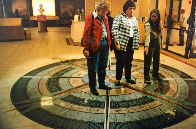 Interest in Lewis and Clark is “sort of this big machine now going down the track, and the more there is of it, the more people gobble it up,” says Jane Webber, right, director of the Lewis and Clark Interpretive Center in Great Falls. The $6 million-center opened on July 4, 1998. The entire story of the expedition is summed up in pictograms on the center’s compass rose, which Webber explained for visitors Ann Bates of Mosinee, Wis. (left), and Linda Kathman, of Philomath, Oregon. (© FlaglerLive)