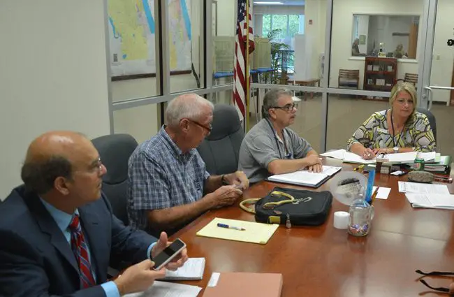 Kimberle Weeks when she was Flagler County's Supervisor of Elections, a few months before she resigned, seen here during a canvassing board meeting. She or her acolytes would file ethics complaints against all three men to the left: County Attorney Al Hadeed, who was also the canvassing board's attorney, and Commissioners Charlie Ericksen and Gorge Hanns. Hanns is no longer on the commission. All three complaints were deemed frivolous and false. (© FlaglerLive)