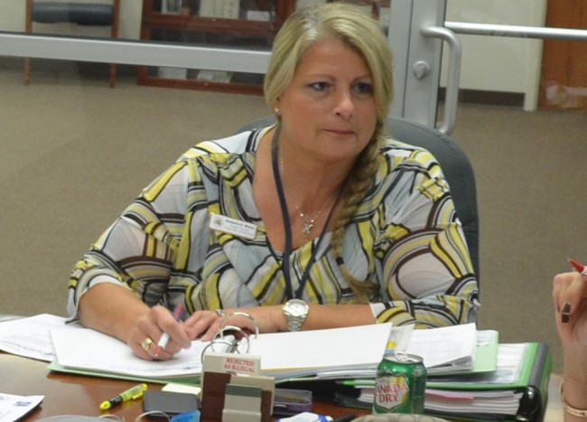 Supervisor of Elections Kimberle Weeks was apparently recording meetings and, at times, conversations that were not taking place within the scope of meetings, with her cell phone, visible here in front of her during an August Canvassing board meeting. Click on the image for larger view. (© FlaglerLive)