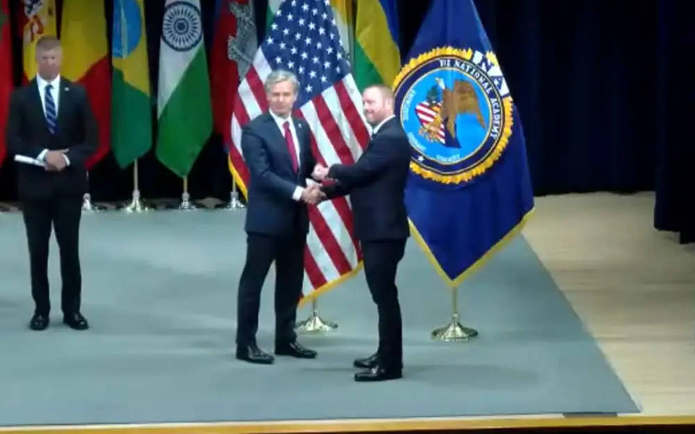 Chief Jonathan Welker's moment on stage. (© FlaglerLive via FBI Academy video)