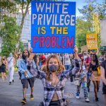 A protestor holds a sign reading ‘White Privilege Is The Problem’ at a rally against policy brutality and racial injustice in New York on Sept. 5, 2020.