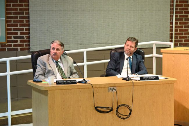 There was no need for hieroglyphs to read the skepticism on City Manager William Whitson's face, left, as Flagler Golf Management officials spoke Thursday evening. City Attorney Drew Smith is to the right. (© FlaglerLive)