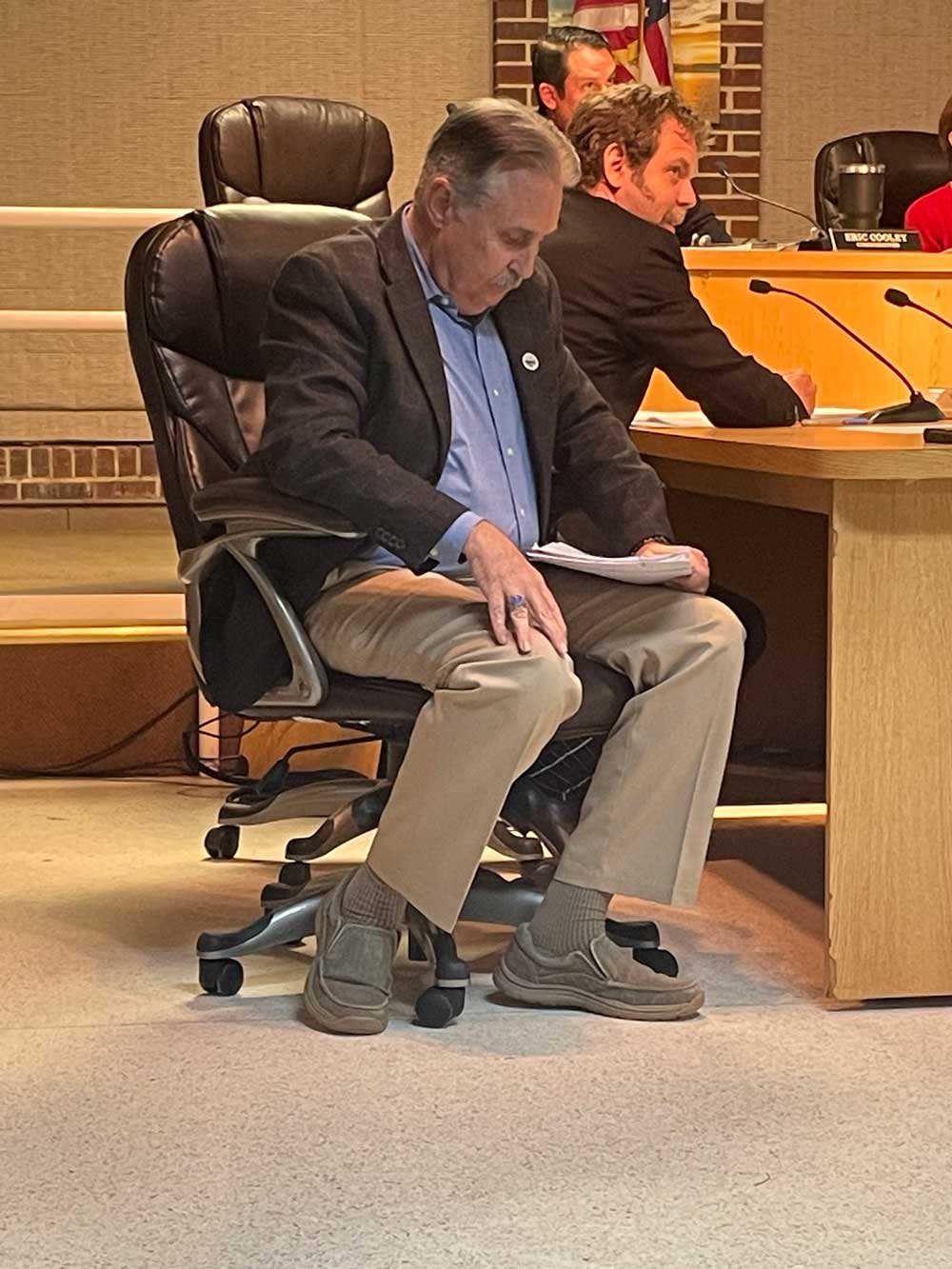 William Whitson this evening, immediately after the city commission's 4-1 vote to fire him. Commissioner Eric Cooley is in the background. (© FlaglerLive)