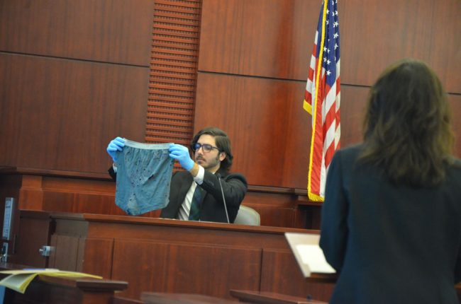 FDLE DNA analyst Nicholas Coutu showing the places in the victim's underwear from which fabric was cut out for DNA testing. (© FlaglerLive)