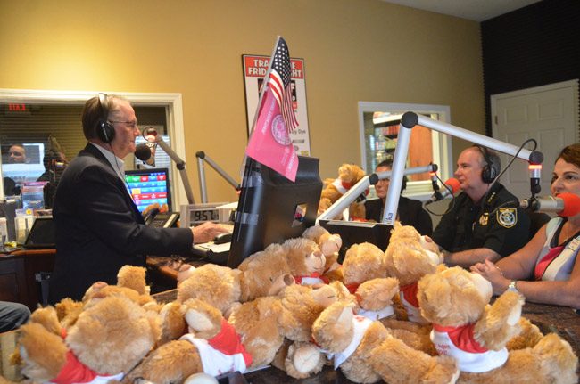 Tim and Lisa Hogan of State Farm donated some 100 teddy bears to the Flagler County Sheriff's Office  so deputies can carry them in their patrol vehicles and hand them out to children involved in domestic violence situations. Sheriff Rick Staly talked about the issue, with the Hogans present, on Free For All Friday last week, with host David Ayres, who arranged for the donation. (© FlaglerLive)