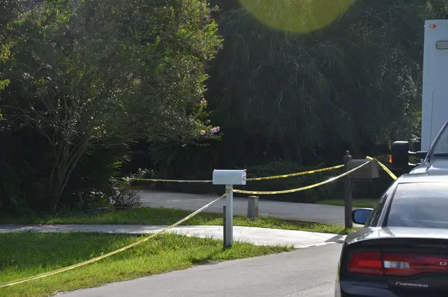The front yard of 47 Woodhollow Lane, where Michele Shimmel was found dead of stab wounds Wednesday evening, was still a crime scene Thursday morning. (© FlaglerLive)