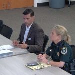 Tommy Wooleyhan, the Flagler County school district's safety specialist, discussing the potential of arming school staffers this afternoon before the Flagler County School Board, with the Sheriff's Office's Commander Jennifer Nawrocki. (© FlaglerLive via Flagler schools TV)