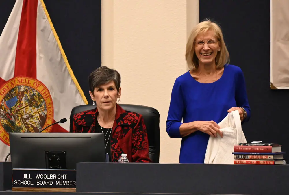 The Flagler County School Board's Jill Woolbright and Janet McDonald on Tuesday. the books to the right were McDonald's. (© FlaglerLive)