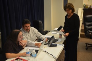 Board Chairman Andy Dance tallying up figures with Board Attorney Kristy Gavin, standing, and Finance Director Patty Wormeck during a 3 p.m. break.  