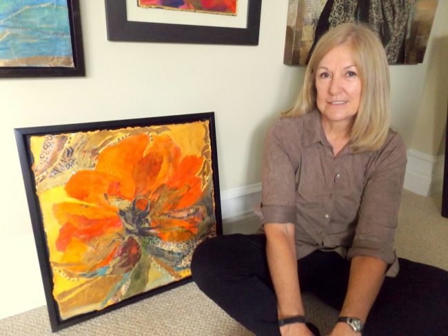 Judi Wormeck poses beside one of her mixed-media works in her 'Poppy' series. The work be part of her solo exhibition at Ocean Art Gallery in Flagler Beach. An opening reception will be 6 to 9 p.m. Friday, March 17. Click on the image for larger view. (© FlaglerLive)