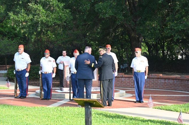 Council members Ty Miller and Charles Gambaro after placing a wreath at the Purple Heart memorial. (© FlaglerLive)