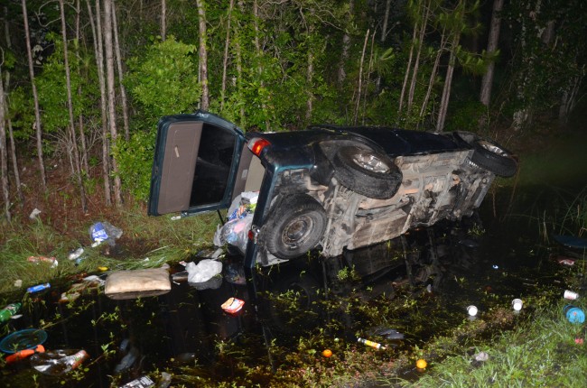 The 1997 Toyota SUV rolled and spun before ending up in a ditch, facing south, off the northbound lanes of U.S. 1 in Palm Coast. Click on the image for larger view. (© FlaglerLive)