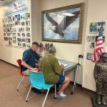 Too easy: back-alley political operative Dennis McDonald last June helping Jose Fabiani fill out the paperwork necessary to be a write-in candidate--and close a County Commission primary to 47,000 voters in August. (© FlaglerLive)