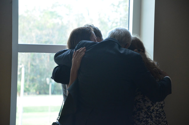 After the verdict Stanley Wykretowicz's father, his wife and one other family member embraced him in an emotional hug outside the courtroom. (© FlaglerLive)