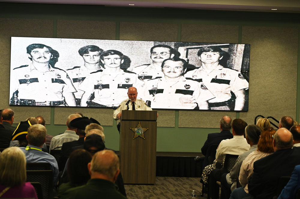 From youth deputy to sheriff over 50 years: Sheriff Rick Staly as he addressed an audience at his commemoration of 50 years in law enforcement, which included a few digs into the archives. (© FlaglerLive)